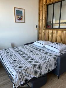 Ένα ή περισσότερα κρεβάτια σε δωμάτιο στο Appartement face à l’Océan