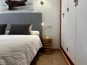 a bedroom with a bed and a lamp next to it at Casa Coromines in Alcudia