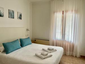 a bedroom with a bed with towels on it at Casa Coromines in Alcudia