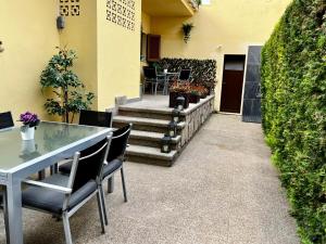 a patio with a table and chairs and stairs at Casa Coromines in Alcudia