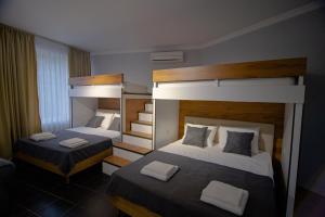 two beds in a room with two bunk beds at Comfy corner in Tʼelavi