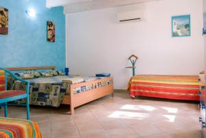 A bed or beds in a room at AFFITTACAMERE L'ARCOBALENO
