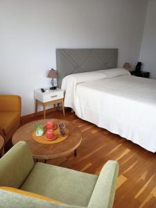 a hotel room with two beds and a coffee table at Casa Valentina in Jávea