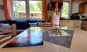 a bottle of wine sitting on top of a kitchen table at Mobil Home Camping Les VIVIERS, Claouey in Claouey
