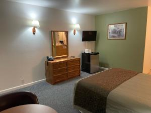 a hotel room with a bed and a mirror at Murphey's Motel LLC in Lee Vining