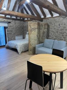 a living room with a blue couch and a table at Loft Casa Bergua in Arguis