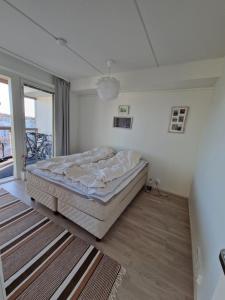 A bed or beds in a room at 62m2 10th floor modern apartment with sauna and view