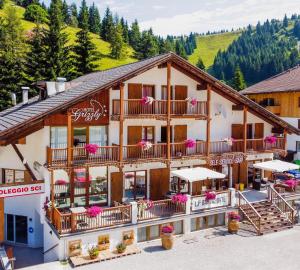 a building with flowers on the balconies of it at Hotel Grizzly in Folgaria