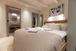 a large white bed in a room with a bathroom at Superior Room Gabriela in Dubrovnik