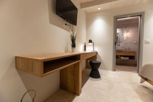 a home office with a wooden desk and a television at Superior Room Gabriela in Dubrovnik