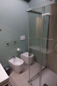 a bathroom with a shower and a toilet and a sink at La dimora Blu in Parma