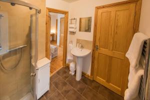 a bathroom with a sink and a shower at Cuillich Mill Bed and Breakfast in the Highlands in Alness