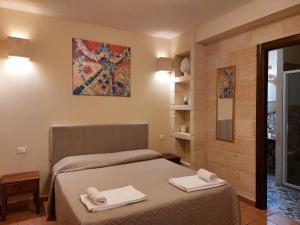 En eller flere senge i et værelse på Villa Rosa Candida