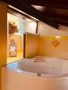 a large bath tub in a bathroom with a window at Il paradiso delle beccacce in Popiglio