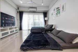 - un salon avec un canapé et une table dans l'établissement Ozzy's home@Banchang, à Ban Chang