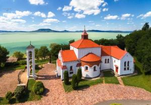 an aerial view of a small white church with an orange roof at House Kalmia in Fonyód