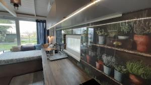a living room with a large wall with plants on it at House Kalmia in Fonyód