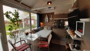 a small kitchen and living room in a tiny house at House Kalmia in Fonyód
