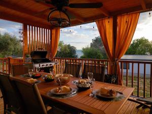 a wooden table on a deck with a stove at MiraMa MobileHome in Selce