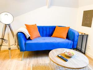 a blue couch in a living room with a table at **NEW** Le Nid Douillet au cœur de Guingamp in Guingamp