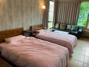 Rúm í herbergi á Mei Nong Villa