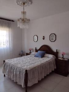 a bedroom with a bed with a blue pillow on it at Apartamento en San Vicente de O Grove in O Grove