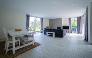 a living room with a table and a blue couch at Villa Rencanto – um espaço com a sua assinatura in Caminha