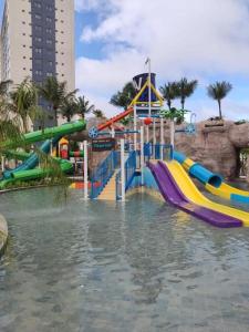 a water park with a water slide in the water at Salinas Premium Resort in Salinópolis