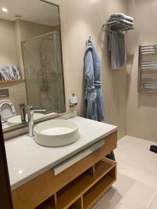 a bathroom with a sink and a mirror at Sea Breeze White Villas in Bilgah