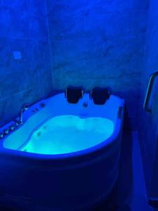 a bathroom with a tub with sunglasses on it at Palmas View Premium 6 in Humacao