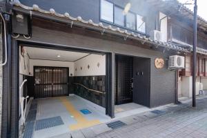 an entrance to a building with a gate and a building at Coto in Miyazu