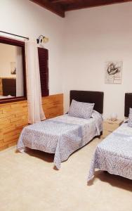 a bedroom with two beds and a window at GRANI MAR in Costa Calma