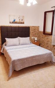 a bedroom with a large bed and a mirror at GRANI MAR in Costa Calma +21 photos