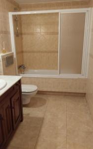 a bathroom with a toilet and a sink and a shower at GRANI MAR in Costa Calma +21 photos