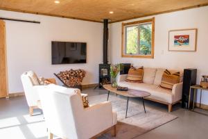 a living room with a couch and a table at Parohe Island Retreat in Auckland