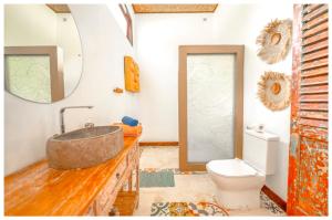 a bathroom with a sink and a toilet at Sriyana Uluwatu in Uluwatu +60 photos