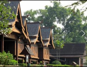 a large wooden house with a gambrel roof at DYAYA Hotel in Malacca