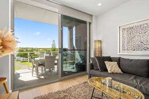 a living room with a couch and a table at Hamptons By The Beach - Moana - C21 SouthCoast Holidays in Moana
