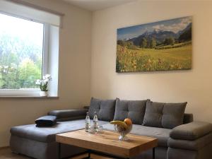 a living room with a couch and a table at Pension und Ferienwohnung Frech in Marktschellenberg
