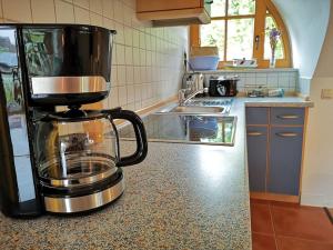 a kitchen with a coffee maker on a counter at Reethaus mit Meerblick- In 30 Sekunden am Strand in Boltenhagen