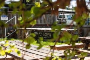 a sign that reads snake creek wildlife company in front of a fence at Royal Hotel Mandurama in Mandurama