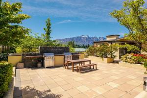 an outdoor patio with a table and a grill at Central Luxury at 407 The Beacon Studio in Queenstown