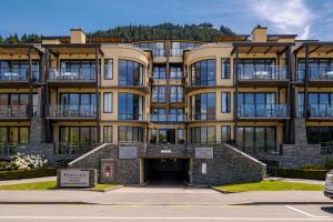 a large apartment building with a parking lot at Central Luxury at 407 The Beacon Studio in Queenstown