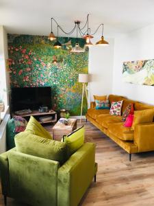 a living room with two couches and a fireplace at The Art Attic a Stylish Boutique Apartment in Builth Wells