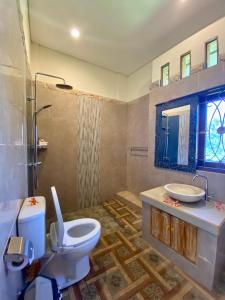 a bathroom with a toilet and a sink at Wiki Bali in Ubud