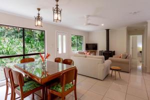 a living room with a table and a couch at Honeybee House in Kuranda