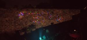 a brick wall with christmas lights on it at NATS Overnight Accommodation Room One Double bed in De Aar