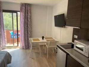 a small kitchen with a table and a microwave at apartamento playa privada in Torre del Mar
