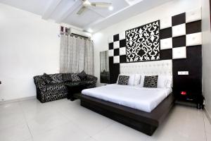 ein Schlafzimmer mit einem Bett und einem Sofa darin in der Unterkunft Collection O Hotel Nayyar in Amritsar
