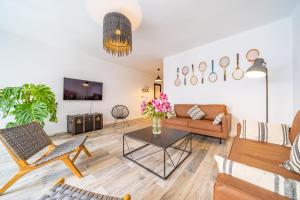a living room with a couch and a table at CAN MARTINEZ Calella Beach Boutique Apartment in Calella